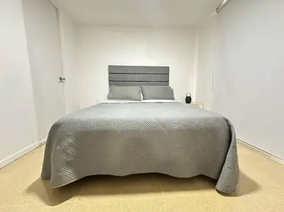 a large bed in a white room with a large bed sidx sidx sidx at Cozy Studio Apartment in Poblado with Jacuzzi in Medellín