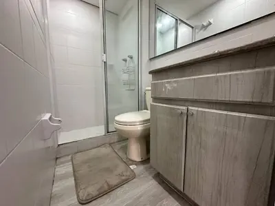 a bathroom with a toilet and a glass shower at Cozy Studio Apartment in Poblado with Jacuzzi in Medellín