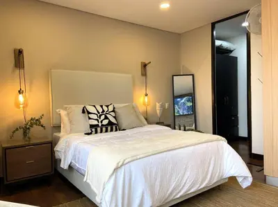 a bedroom with a large white bed and a mirror at Elegance in Provenza in El Poblado