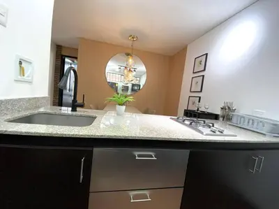 a kitchen with a sink and a large mirror at Elegance in Provenza in El Poblado