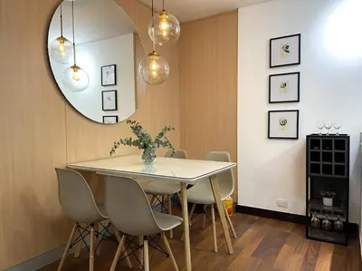 a dining room with a table and chairs and a mirror at Elegance in Provenza in El Poblado