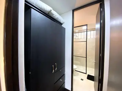 a black door in a room with a mirror at Elegance in Provenza in El Poblado