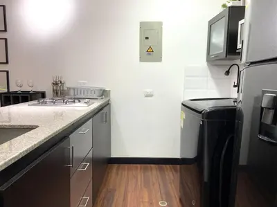 a kitchen with a sink and a stove top oven at Elegance in Provenza in El Poblado