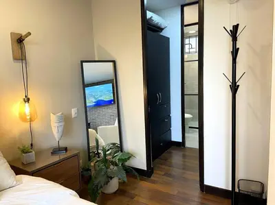 a bedroom with a mirror and a bed and a table at Elegance in Provenza in El Poblado