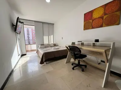 a bedroom with a desk and a bed and a desk sidx sidx sidx sidx sidx at Magical Laureles in Medellín