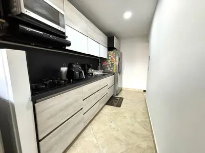 a kitchen with a stove and a microwave at Magical Laureles in Medellín