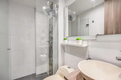 a bathroom with a sink and a toilet and a shower at Aparta Estudio en Edificio La Frontera in Medellín