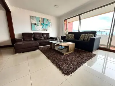 a living room with a couch and a coffee table at Serene Laureles in América