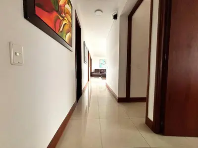 a hallway with white walls and a painting on the wall at Serene Laureles in América