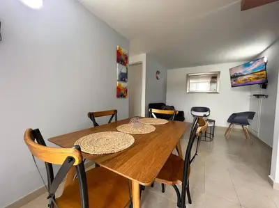 a dining room with a wooden table and chairs at Serenity in Poblado in El Poblado