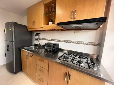 a kitchen with a stove and a refrigerator at Serenity in Poblado in El Poblado