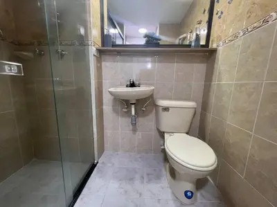 a bathroom with a toilet and a sink at Serenity in Poblado in El Poblado