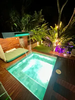 a swimming pool at night with a water feature at Cabaña Cedro Amarillo - Jacuzzi Grande Con Calefacción - Cerca a Medellín in Sopetran