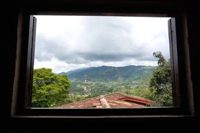 a window view of a mountain view from a house at Casa Familiar y Naturaleza en Parcelación Privada in Amagá