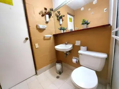 a bathroom with a toilet and a sink at Casa Familiar y Naturaleza en Parcelación Privada in Amagá