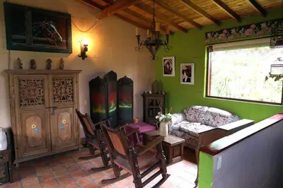 a living room with a couch and a table and chairs at Casa Familiar y Naturaleza en Parcelación Privada in Amagá