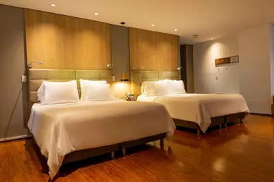 a hotel room with two beds with white pillows at Quo Quality Hotel in Manizales