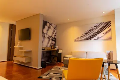 a living room with a couch and a table at Quo Quality Hotel in Manizales