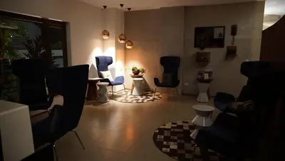 a living room with chairs and a table and lights at Quo Quality Hotel in Manizales