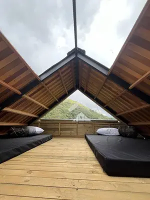 a room with two beds in a room with a window at Tambo 3 Carriquí - Reserva Natural Salto del Buey in Montebello