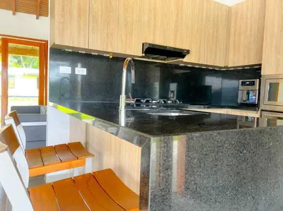 a kitchen with a counter with a sink and a stove at 15 mins to Jardín Spacious & Convenient House in Los Andes