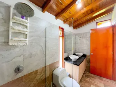 a bathroom with a glass shower and a sink at 15 mins to Jardín Spacious & Convenient House in Los Andes