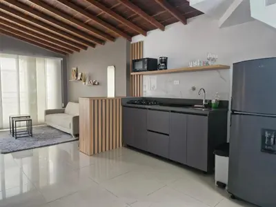 a kitchen with a refrigerator and a stove top oven at 302 Apartamento Completo en Medellín in Medellín