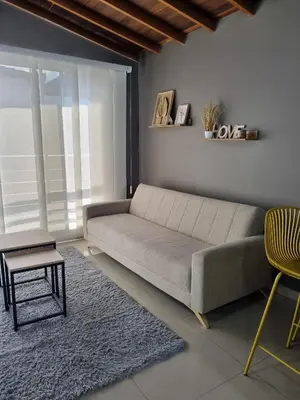 a living room with a couch and a table at 302 Apartamento Completo en Medellín in Medellín