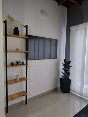 a room with a book shelf and a white wall at 302 Apartamento Completo en Medellín in Medellín