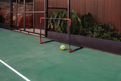 a soccer ball sitting on a tennis court at Luxurious Farm House in Rionegro