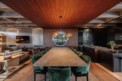 a dining room with a table and green chairs at Luxurious Farm House in Rionegro