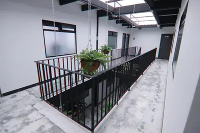a balcony with potted plants on a building at Hotel Casa Laureles Malibú in Medellín