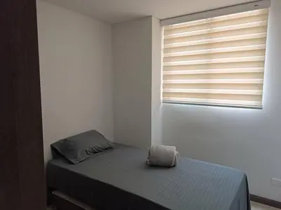a small bedroom with a bed and a window at Oasis urbano, cerca a todo, a una cuadra del metro in Sabaneta