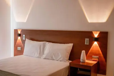 a bedroom with a bed with a wooden head board at Crisalida Apartamento in Sabaneta
