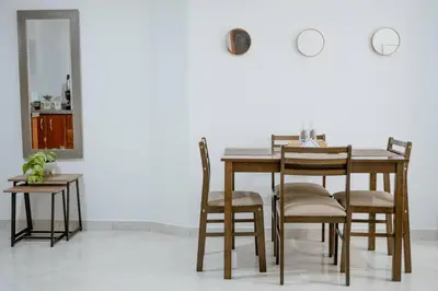 a dining room table with chairs and a mirror at Crisalida Apartamento in Sabaneta