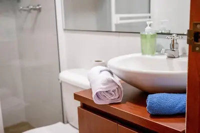 a bathroom with a sink and a toilet and a mirror at Crisalida Apartamento in Sabaneta