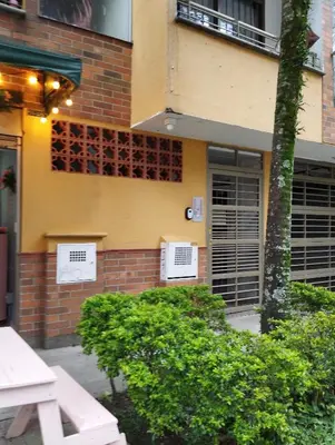 a building with two air conditioners on the side of it at Crisalida Apartamento in Sabaneta