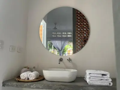 a bathroom with a white sink and a mirror at Casa de la Cruz in Mariquita