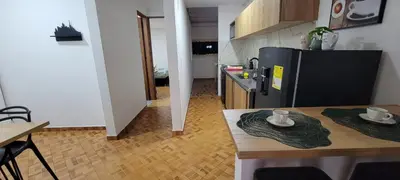 a kitchen with a table and a black refrigerator at Luxury Room San Nicolás Mall in Rionegro
