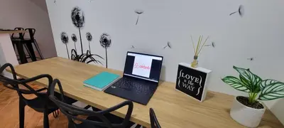 a laptop computer sitting on top of a wooden table at Luxury Room San Nicolás Mall in Rionegro