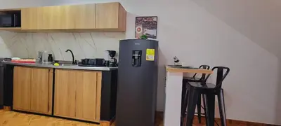a kitchen with a refrigerator and a counter top at Luxury Room San Nicolás Mall in Rionegro