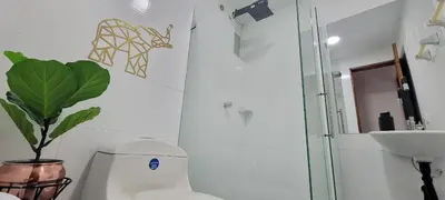 a bathroom with a toilet and a sink and a plant at Luxury Room San Nicolás Mall in Rionegro
