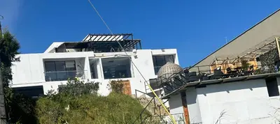 a white building with a balcony on top of it at Beverly Hills Mansion room only in Guarne