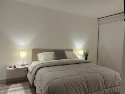 a bedroom with a large bed with two lamps at Apartamento Exclusivo Manizales in Manizales