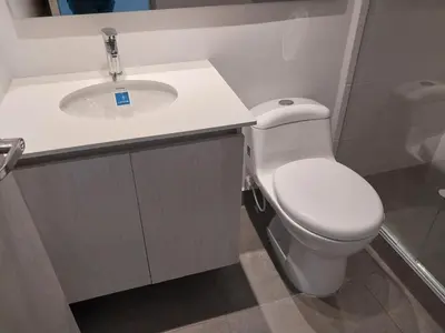 a bathroom with a white toilet and a sink at Apartamento Exclusivo Manizales in Manizales