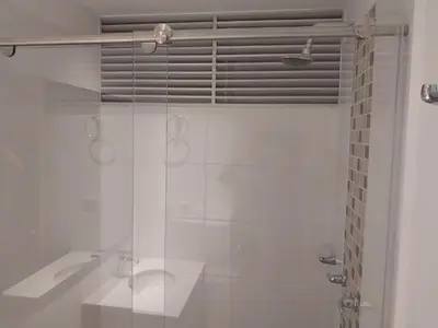 a white bathroom with a shower and a tub at Apartamento Exclusivo Manizales in Manizales