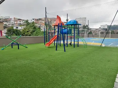 a playground with a slide on a field of grass at Apartamento Exclusivo Manizales in Manizales