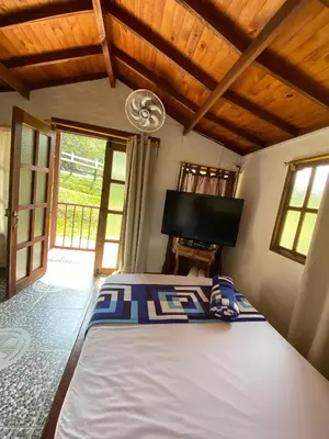 a bedroom with a large bed in a room at Ecohotel La Italia- Hotel Venecia, Antioquia in Venecia