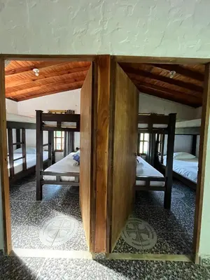 a room with three bunk beds in a house at Ecohotel La Italia- Hotel Venecia, Antioquia in Venecia