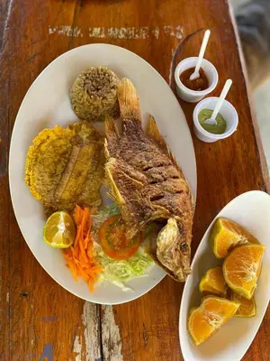 a plate of food with meat and vegetables on a table at Ecohotel La Italia- Hotel Venecia, Antioquia in Venecia
